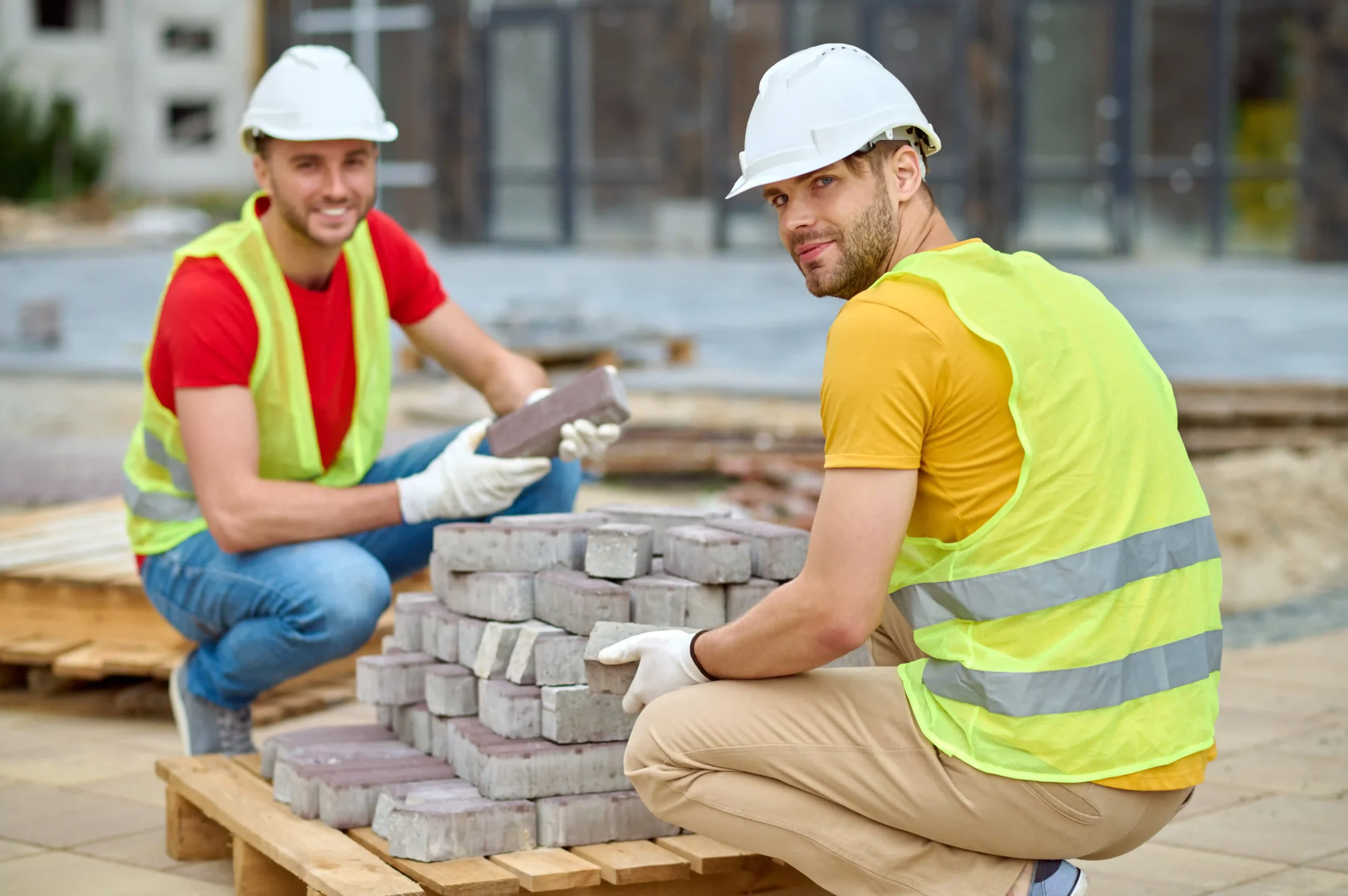 two-workers-stacking-bricks